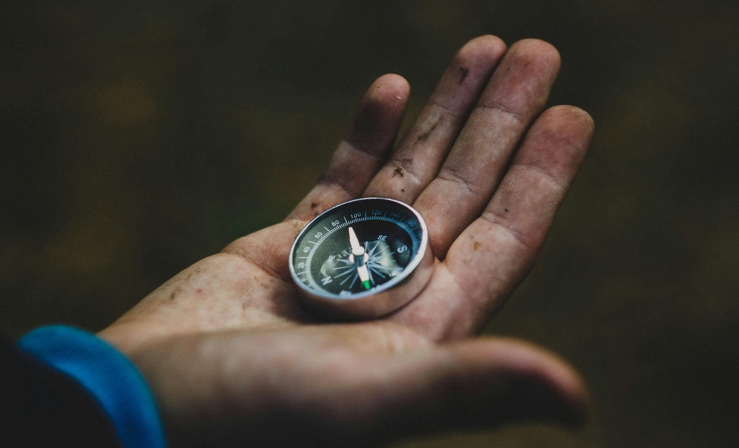 Hand holding compass symbolizing emotional clarity and inner direction in therapy